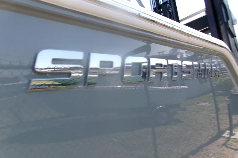 Slide: The Image of 2026 Sportsman Open 252 Center Console boat logo on sleek exterior. - 3