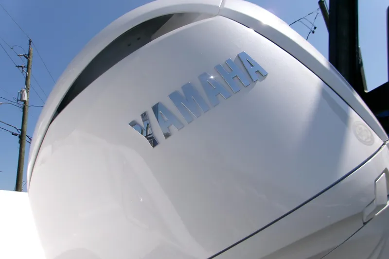 Slide: The Image of Yamaha engine on 2026 Sportsman Open 252 Center Console boat under clear sky. - 5
