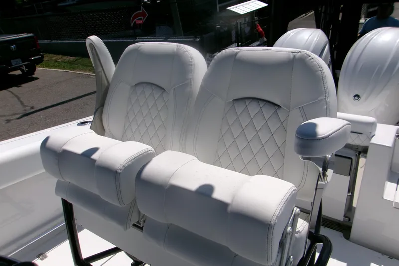 Slide: The Image of 2026 Sportsman Open 252 Center Console boat with luxurious white seating. - 8