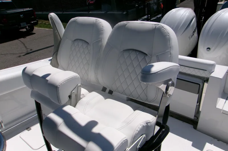 Slide: The Image of 2026 Sportsman Open 252 Center Console boat seats with diamond stitching and armrests. - 9