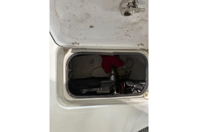 Slide: The Image of Open storage compartment in a 2018 Majek 22 Xtreme boat, showing interior contents. - 7