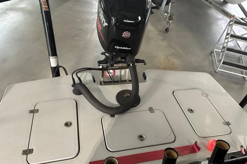 Slide: The Image of 2018 Majek 22 Xtreme boat with Mercury OptiMax engine in a garage setting. - 8
