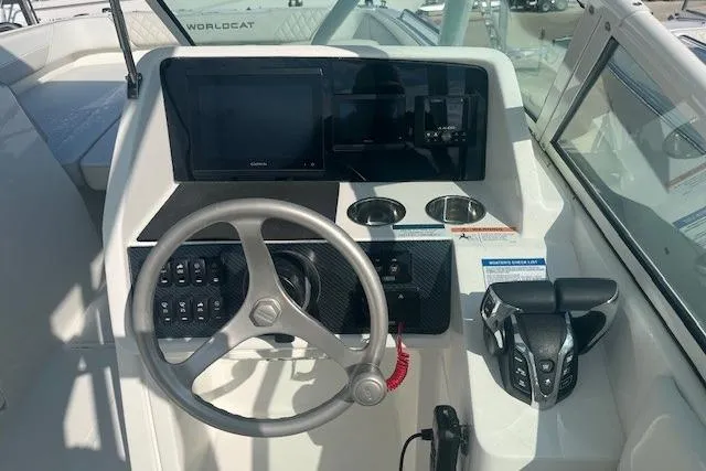 Slide: The Image of Helm of 2026 World Cat 230 SD boat with steering wheel and control panel. - 4