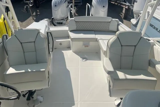 Slide: The Image of 2026 World Cat 230 SD boat interior with white seating and dual outboard motors. - 5