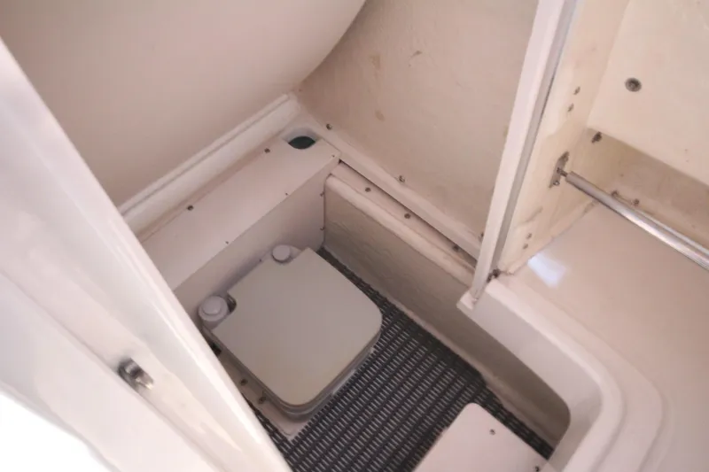 Slide: The Image of 2016 Robalo R200 Center Console boat interior with compact marine toilet. - 13