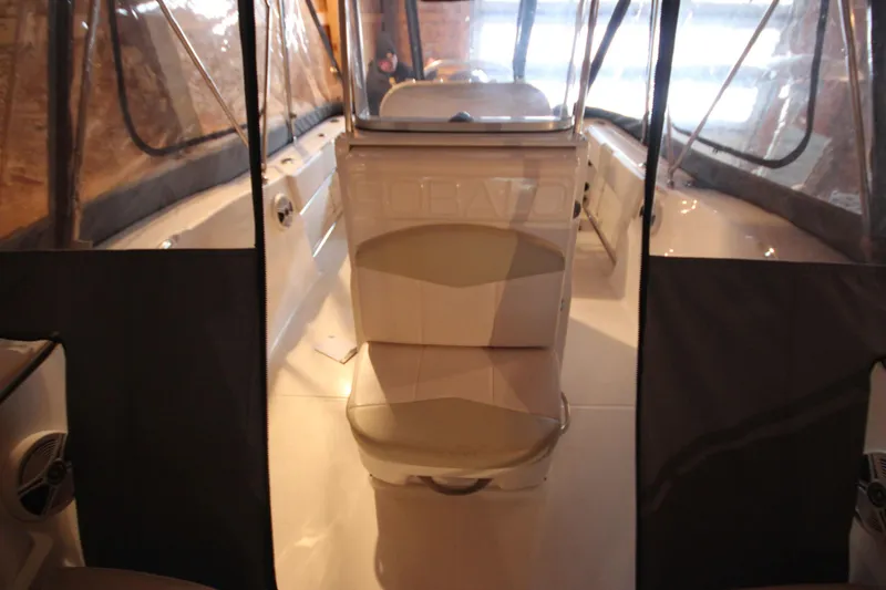 Slide: The Image of 2016 Robalo R200 Center Console boat interior with seating and protective covers. - 16