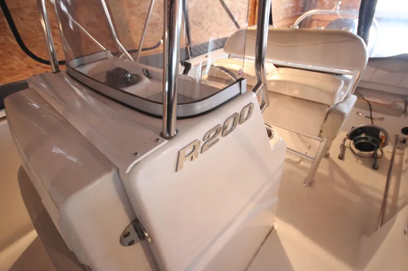 Slide: The Image of 2016 Robalo R200 Center Console boat interior with steering console and seating. - 17