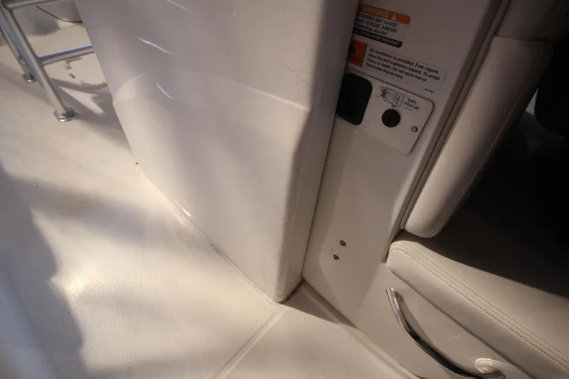 Slide: The Image of Interior view of a 2016 Robalo R200 Center Console boat, featuring seating and safety labels. - 21