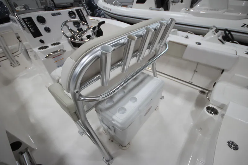 Slide: The Image of 2016 Robalo R200 Center Console boat interior with helm, rod holders, and cooler. - 33