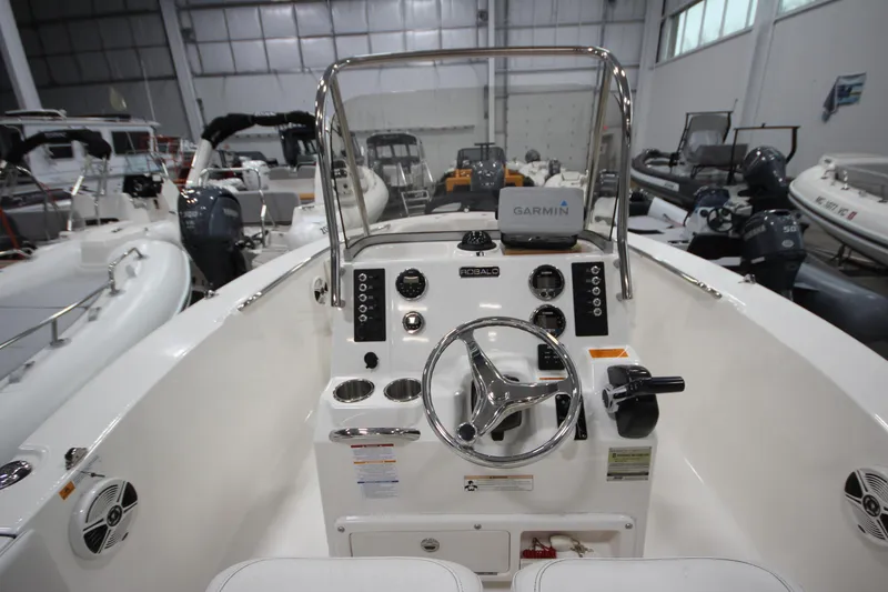 Slide: The Image of 2016 Robalo R200 Center Console boat interior with Garmin navigation system in a showroom. - 35