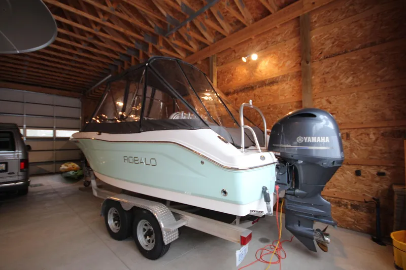 Slide: The Image of 2016 Robalo R200 Center Console boat with Yamaha engine in a garage. - 4