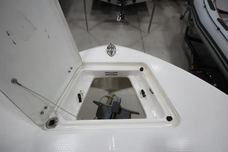 Slide: The Image of 2016 Robalo R200 Center Console anchor storage compartment open, showcasing interior details. - 43