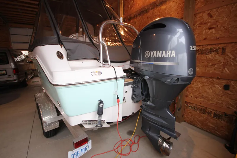 Slide: The Image of 2016 Robalo R200 Center Console boat with Yamaha outboard motor in a garage. - 5