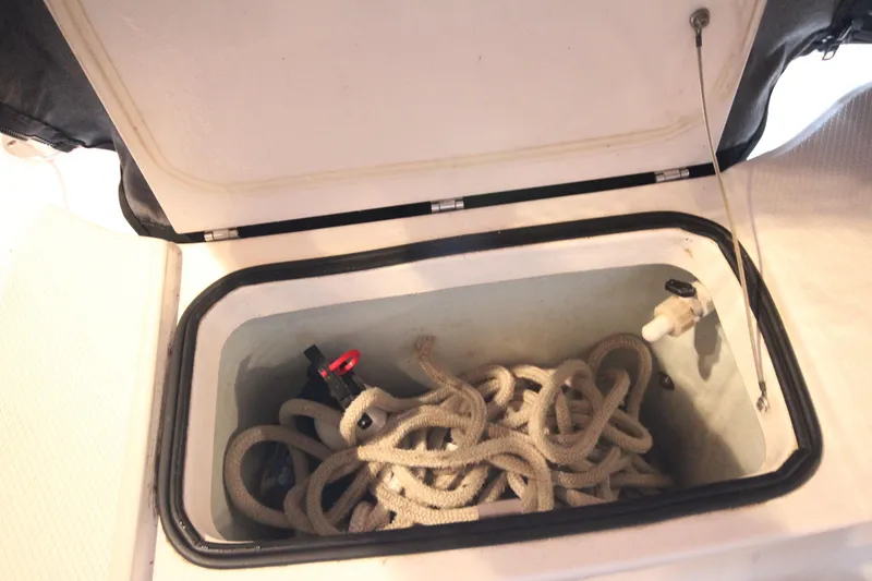 Slide: The Image of Open storage compartment with rope in 2016 Robalo R200 Center Console boat. - 9