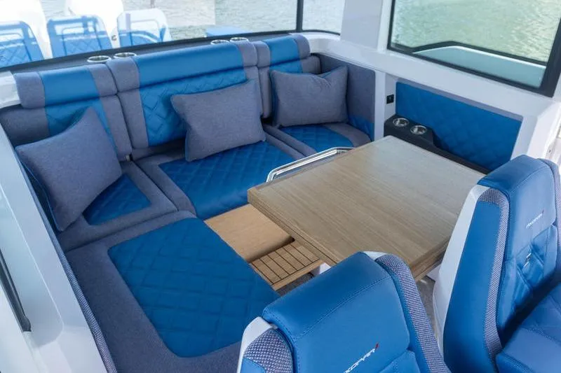 Slide: The Image of Luxurious interior of 2026 Axopar 37 XC Cross Cabin with blue seating and wooden table. - 10