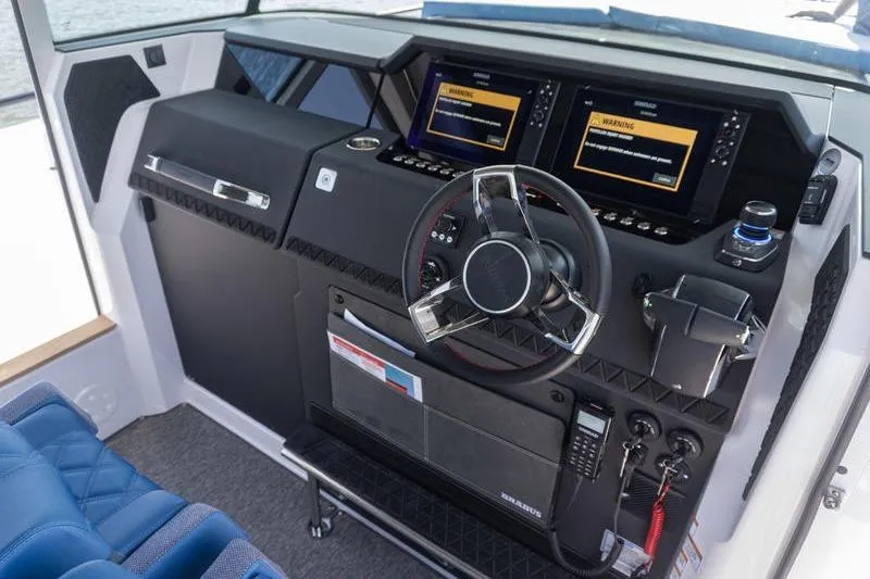 Slide: The Image of 2026 Axopar 37 XC Cross Cabin helm with modern controls and dual displays. - 11