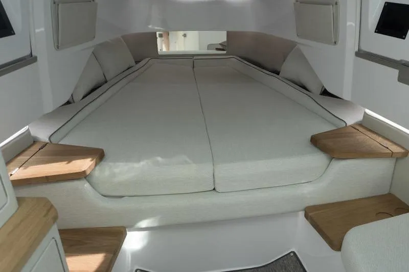 Slide: The Image of 2026 Axopar 37 XC Cross Cabin interior with spacious bed and modern design. - 12