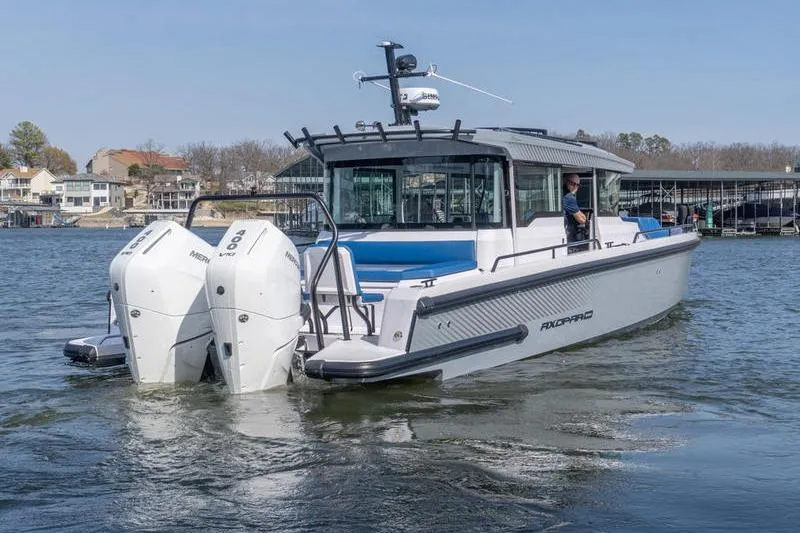 Slide: The Image of 2026 Axopar 37 XC Cross Cabin boat on water with dual engines. - 3