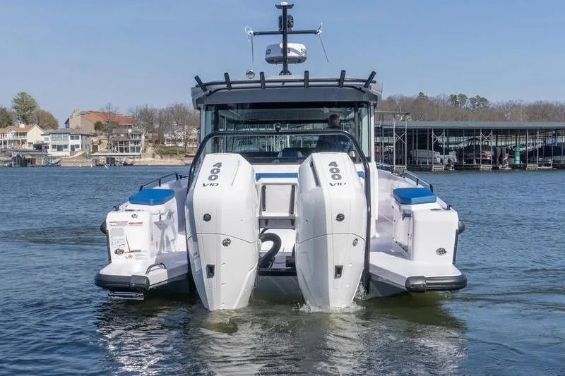 Slide: The Image of 2026 Axopar 37 XC Cross Cabin with dual 400 V10 engines on a lake. - 4