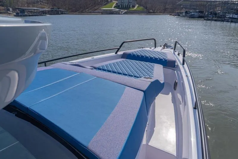 Slide: The Image of 2026 Axopar 37 XC Cross Cabin boat with blue sunbathing cushions on deck. - 7
