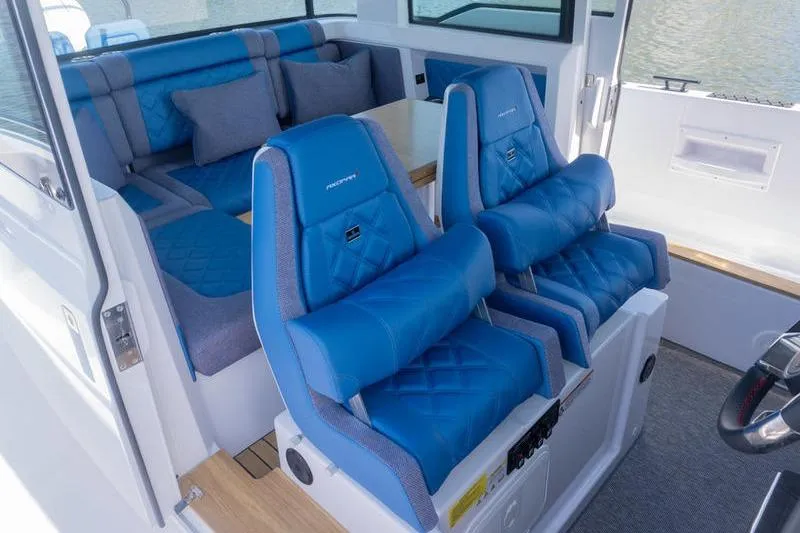 Slide: The Image of 2026 Axopar 37 XC Cross Cabin interior with blue seating and modern design. - 9