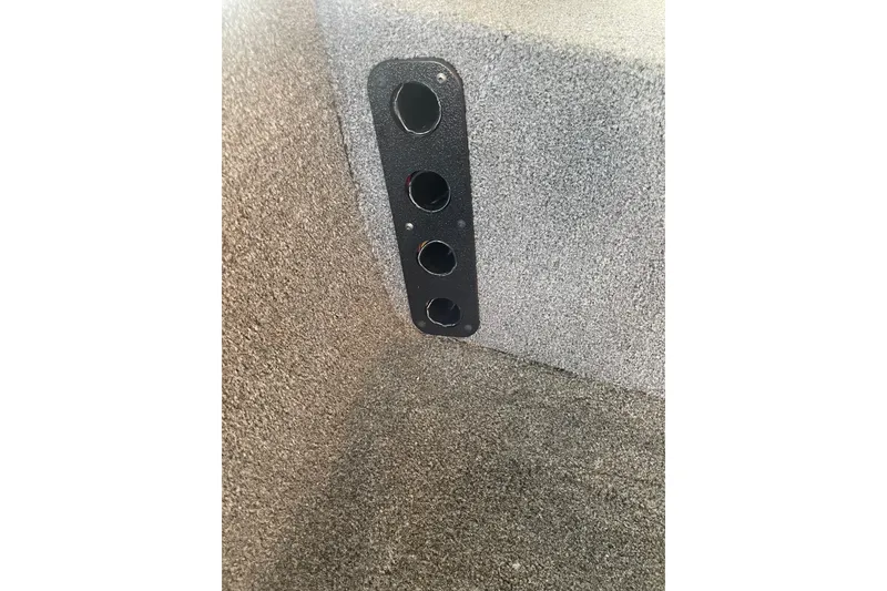 Slide: The Image of 2024 Tracker Bass Tracker Classic XL interior with carpeted finish and panel detail. - 11