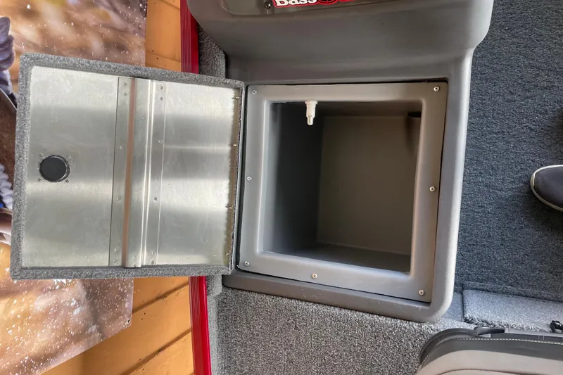 Slide: The Image of 2024 Tracker Bass Tracker Classic XL storage compartment with open lid, showcasing interior space. - 12