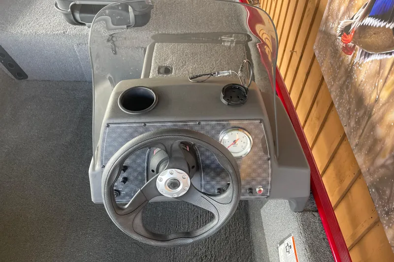 Slide: The Image of 2024 Tracker Bass Tracker Classic XL boat dashboard with steering wheel and gauge. - 3