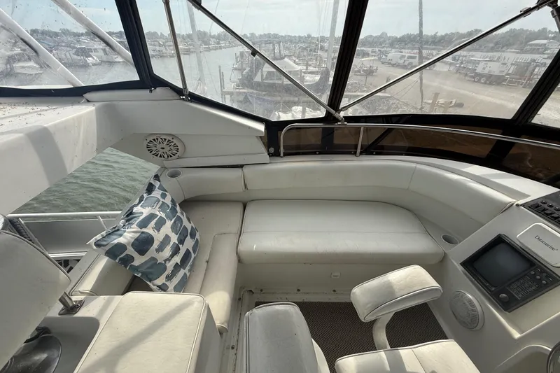 Slide: The Image of Interior of 1992 Silverton 41 Motor Yacht with white seating and nautical decor. - 10