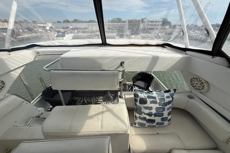 Slide: The Image of Interior view of 1992 Silverton 41 Motor Yacht with white seating and decorative pillows. - 11