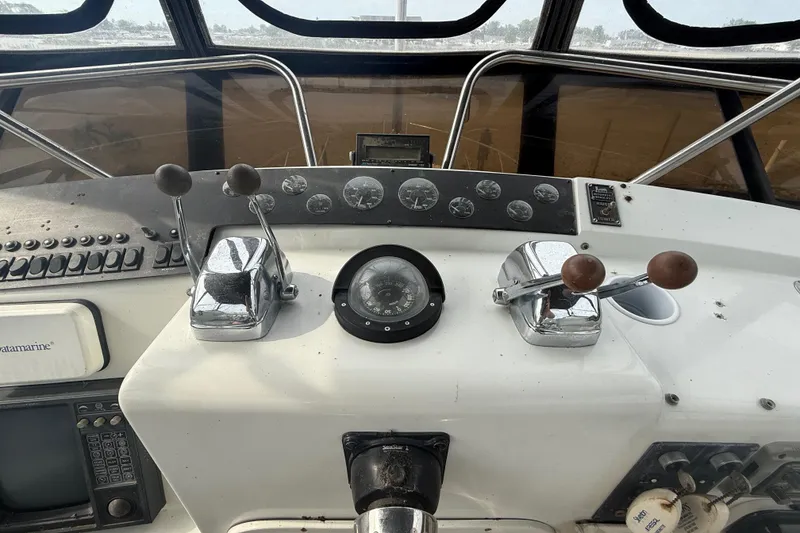 Slide: The Image of Control panel of a 1992 Silverton 41 Motor Yacht with navigational instruments. - 14