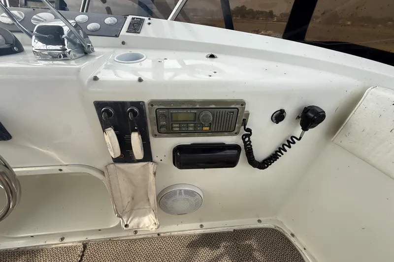 Slide: The Image of 1992 Silverton 41 Motor Yacht helm with radio, controls, and speaker. - 16
