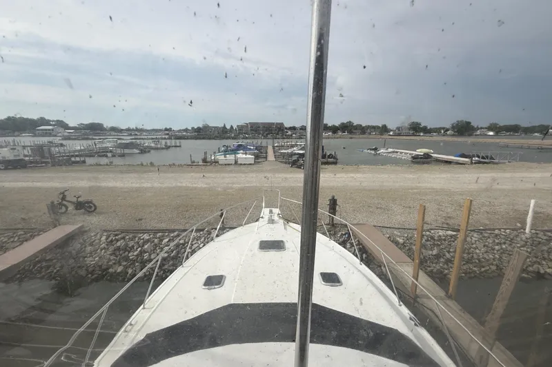 Slide: The Image of 1992 Silverton 41 Motor Yacht docked at a marina with a scenic waterfront view. - 17