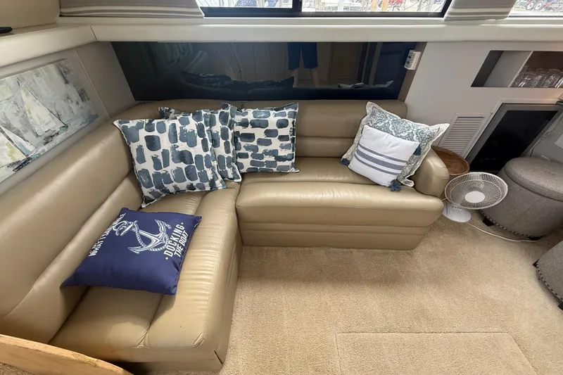 Slide: The Image of Interior of 1992 Silverton 41 Motor Yacht with beige leather seating and decorative pillows. - 21