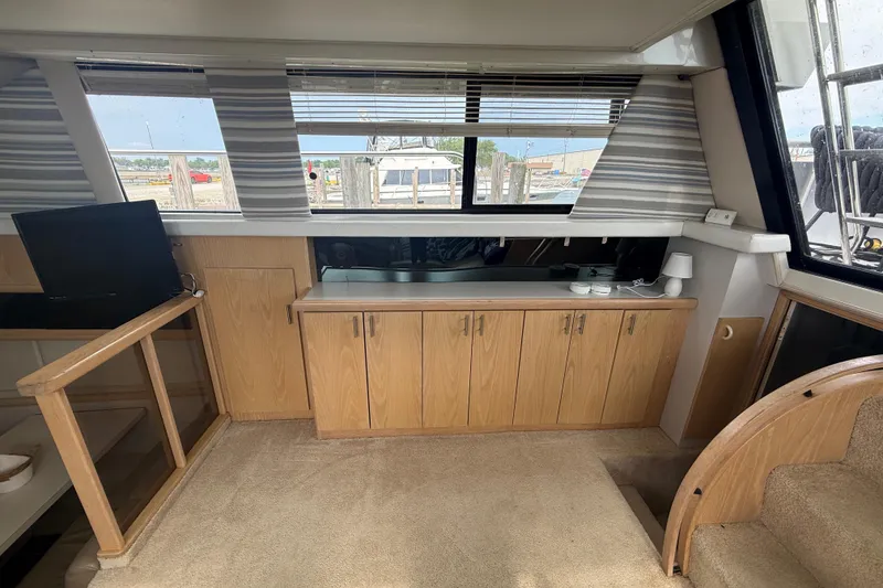 Slide: The Image of Interior of 1992 Silverton 41 Motor Yacht with wooden cabinets and carpeted flooring. - 23
