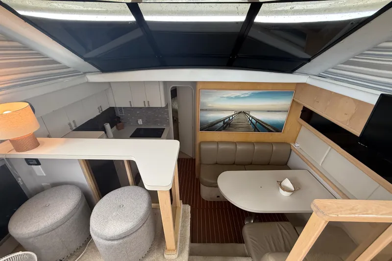 Slide: The Image of Interior of 1992 Silverton 41 Motor Yacht with modern kitchen and cozy dining area. - 24