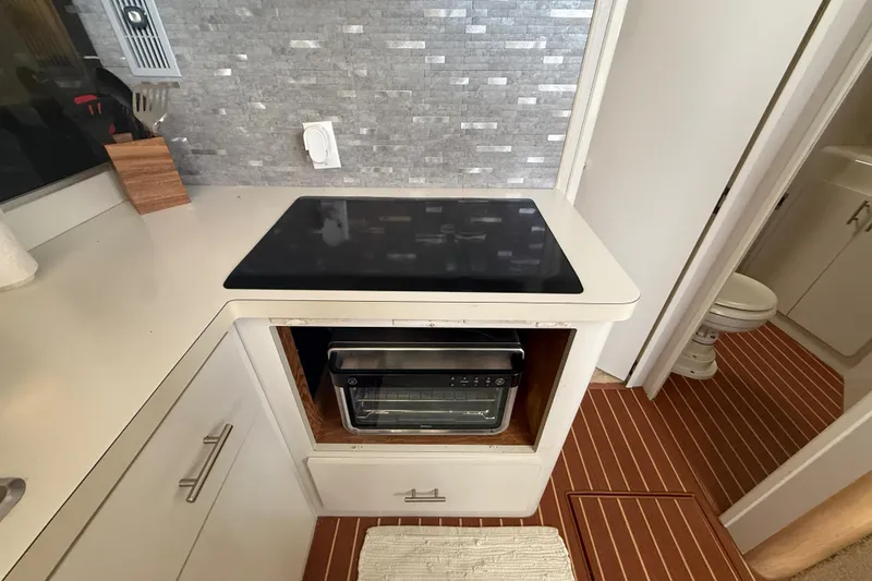 Slide: The Image of Kitchen area of a 1992 Silverton 41 Motor Yacht with stove and oven. - 28