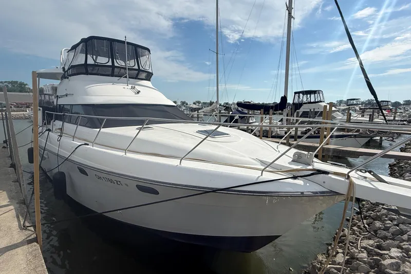Slide: The Image of 1992 Silverton 41 Motor Yacht docked at marina under clear sky. - 3