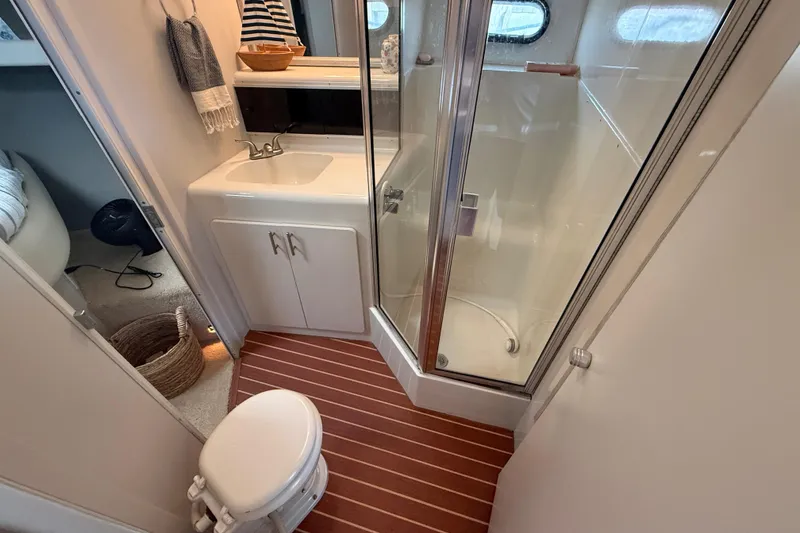 Slide: The Image of Bathroom interior of 1992 Silverton 41 Motor Yacht with shower, sink, and toilet. - 30