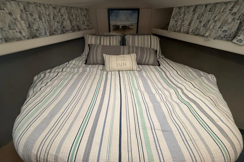 Slide: The Image of Cozy bedroom in 1992 Silverton 41 Motor Yacht with striped bedding and decorative pillows. - 34