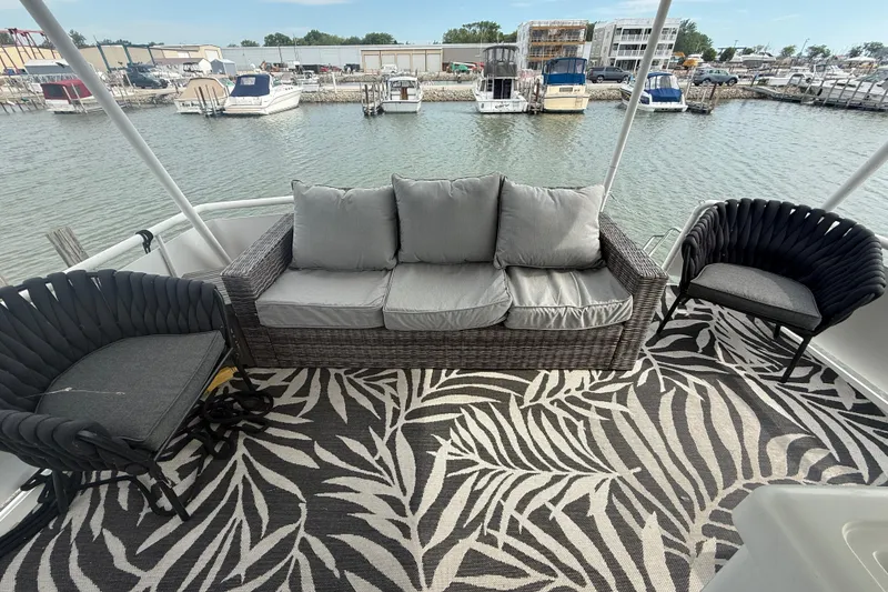 Slide: The Image of Luxurious 1992 Silverton 41 Motor Yacht deck with stylish seating and marina view. - 4