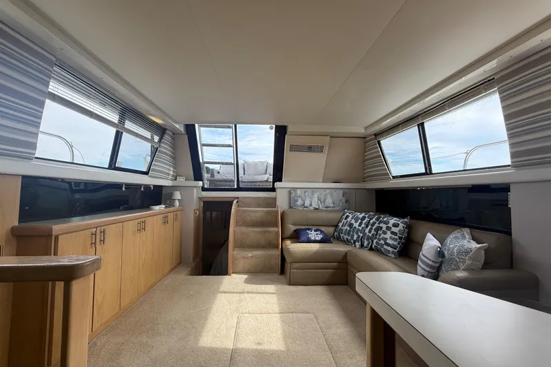 Slide: The Image of Interior of 1992 Silverton 41 Motor Yacht with cozy seating and ample natural light. - 40