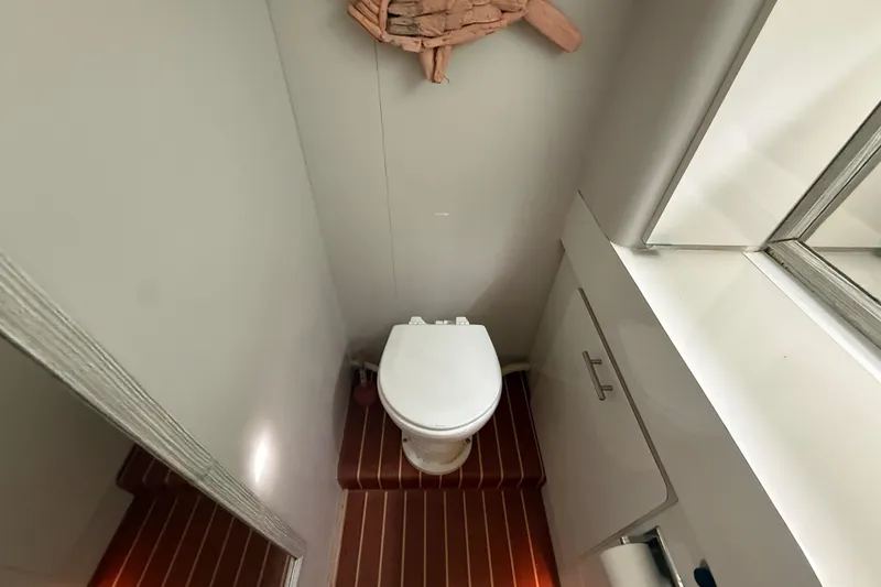 Slide: The Image of Bathroom interior of 1992 Silverton 41 Motor Yacht with toilet and cabinet. - 46