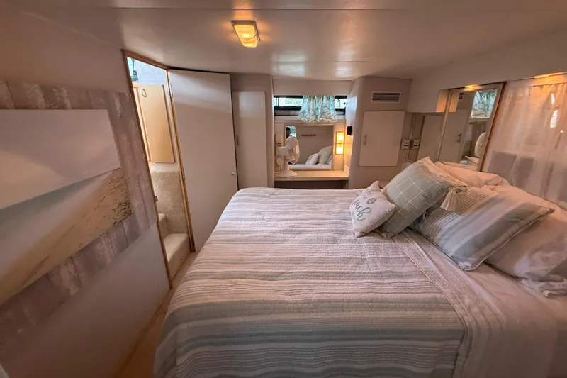 Slide: The Image of Cozy bedroom interior of 1992 Silverton 41 Motor Yacht with stylish decor and comfortable bedding. - 48