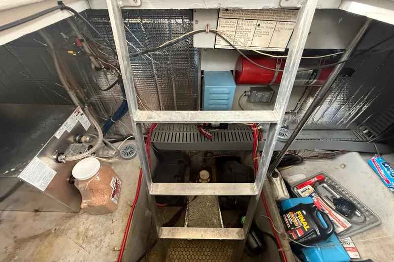 Slide: The Image of Engine room of a 1992 Silverton 41 Motor Yacht with maintenance tools and equipment. - 49