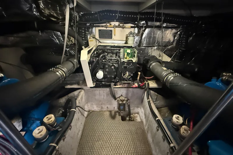 Slide: The Image of Engine room of a 1992 Silverton 41 Motor Yacht, showcasing mechanical components and wiring. - 50