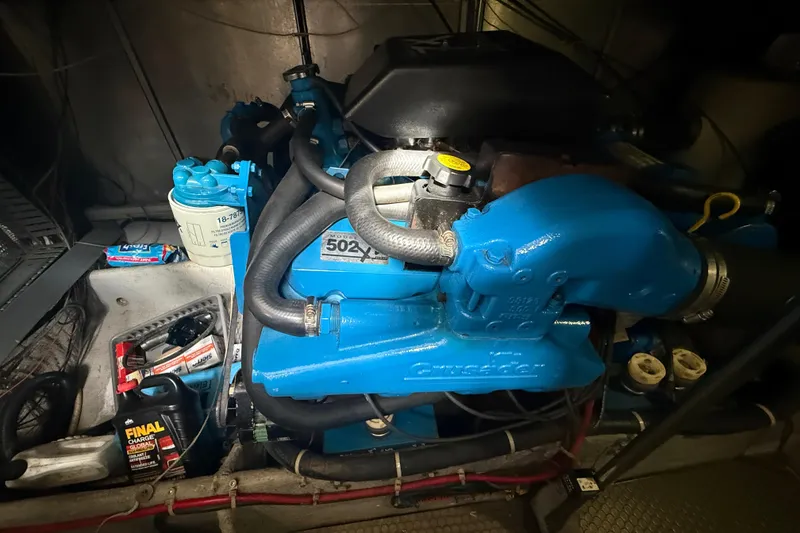 Slide: The Image of Engine room of a 1992 Silverton 41 Motor Yacht with blue engine components. - 51
