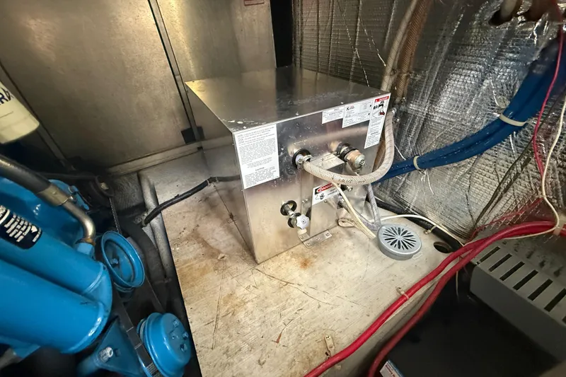Slide: The Image of Engine room of a 1992 Silverton 41 Motor Yacht with mechanical components. - 53