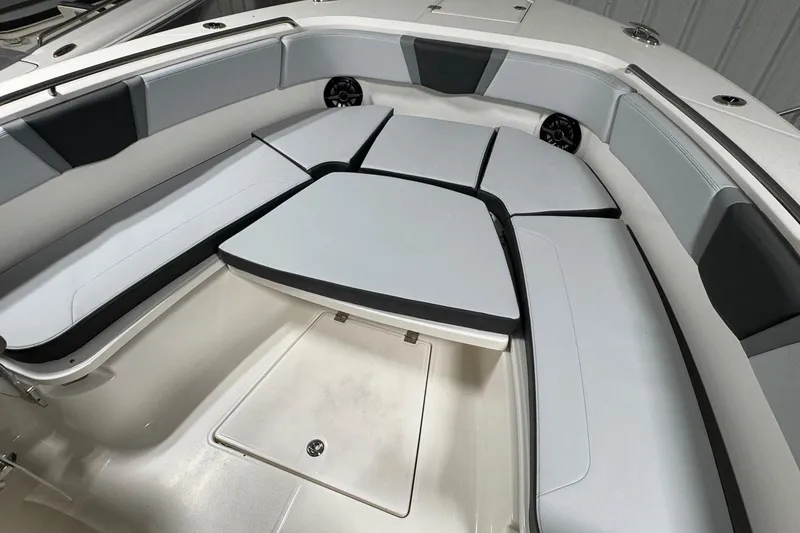 Slide: The Image of 2026 Robalo R300 Center Console boat interior with cushioned seating and storage compartment. - 12