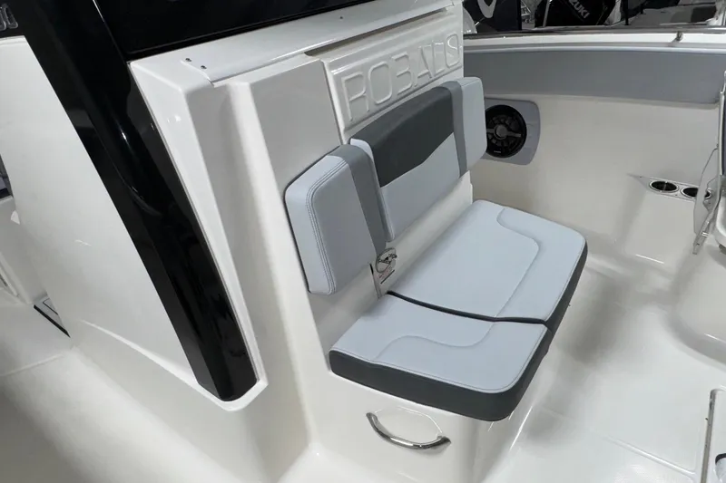 Slide: The Image of 2026 Robalo R300 Center Console boat interior with cushioned seating and sleek design. - 13